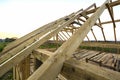 New wooden ecological house from natural materials under construction. Close-up detail of attic roof frame against clear sky from Royalty Free Stock Photo