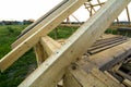 New wooden ecological house from natural materials under construction. Close-up detail of attic roof frame against clear sky from Royalty Free Stock Photo