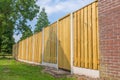 New wooden fence construction with brick wall Royalty Free Stock Photo