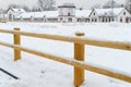 New wooden fence corral for outdoor horses. Empty Horse paddock covered with snow Royalty Free Stock Photo