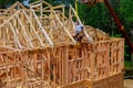 New wooden house from natural materials under construction. Close-up detail of attic roof frame construction