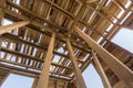New wooden house under construction. Close-up of walls and roof frame made of planks, beams and boards from inside. Ecological hom Royalty Free Stock Photo