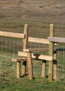 New wooden stile over wire fence in countryside