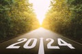 The new year 2024 or straightforward concept. Text 2024 written on the road.
