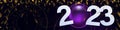 Numbers 2023 with purple christmas ball. Stylized clock and gold foil on a dark background