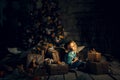 New year activity indoor. Happy Baby Near Christmas Tree With Gifts and mandarines. Fabulous fairytale plot Royalty Free Stock Photo