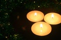 3 candles and Christmas garlands. Festive atmosphere. Royalty Free Stock Photo