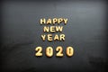 2020 new year background. Baked letters Happy New year and numbers 2020, stars, snowflakes on a black background Royalty Free Stock Photo