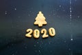 2020 new year background. Baked letters Happy New year and numbers 2020, stars, snowflakes on a black background Royalty Free Stock Photo