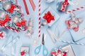 New Year background - bright blue, red and silver metallic gift boxes with ribbons, snowflakes, bows, christmas tree, straws. Royalty Free Stock Photo