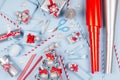 New Year background - bright blue, red and silver metallic gift boxes with ribbons, snowflakes, bows, paper roll, christmas tree. Royalty Free Stock Photo