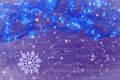 New Year background. Garland with blue lights on a wooden background.