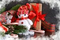 New Year background with gifts, sweets and a snowman. Royalty Free Stock Photo