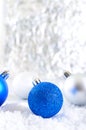 New Year banner with blue, silver and white Christmas balls in snow on abstract winter background. Royalty Free Stock Photo