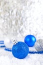 New Year banner with blue, silver and white Christmas balls in snow on abstract winter background. Royalty Free Stock Photo