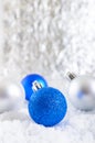 New Year banner with blue, silver and white Christmas balls in snow on abstract winter background. Royalty Free Stock Photo