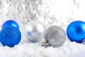 New Year banner with blue, silver and white Christmas balls in snow on abstract winter background Royalty Free Stock Photo