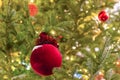 New Year base design, on a Christmas tree branch a red toy in the shape of a bag with gifts hangs, selective focus, colorful Royalty Free Stock Photo