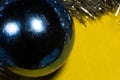 New Year blue bubble with silver tinsel on a yellow background