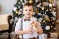 New year. Boy playing near the Christmas tree Royalty Free Stock Photo