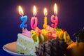 New Year 2019. Burning holiday candles on cake and bump. Close-up