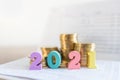 2021 New year, Business, Saving and Planning Concept. Close up of colorful wooden number on bank passbook with stack of gold coins Royalty Free Stock Photo