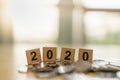 2020 New year, Business, Saving and Planning Concept. Close up of wooden number block toy on pile of coins with copy space Royalty Free Stock Photo