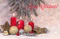 New Year card. Christmas red candles in light Christmas decoration, a wreath of fir branches, glass balls and stars on a light bac Royalty Free Stock Photo