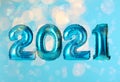 2021 New Year celebration. Bright balloons and blurred lights on blue background Royalty Free Stock Photo