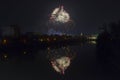 New Year celebration colorful fireworks sparkling in midnight sky over the city of Arad and Mures River, Romania Royalty Free Stock Photo