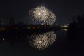 New Year celebration colorful fireworks sparkling in midnight sky over the city of Arad and Mures River, Romania Royalty Free Stock Photo