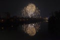 New Year celebration colorful fireworks sparkling in midnight sky over the city of Arad and Mures River, Romania Royalty Free Stock Photo