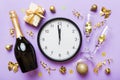 New year celebration concept with a bottle of champagne and two glasses toasting. Christmas gift box, alarm clock and Royalty Free Stock Photo