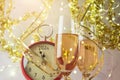 New Year 2024 celebration festive background with champagne glasses and clock over golden bokeh lights Royalty Free Stock Photo