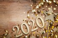 New Year celebration and festive background with golden numbers 2020, confetti stars and Christmas decorations top view