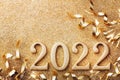 New Year celebration and festive background with golden numbers 2022, streamers and Christmas decorations top view Royalty Free Stock Photo
