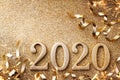 New Year celebration and festive background with golden numbers 2020, streamers and Christmas decorations top view Royalty Free Stock Photo