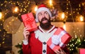 New year celebration. Man bearded santa celebrate christmas with presents. Santa claus hold gift box. Celebrate with joy Royalty Free Stock Photo