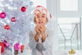 Portrait of happy preteen boy in red Santa Claus hat looking through heart of Christmas candy canes, holding sweets in Royalty Free Stock Photo