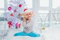 Portrait of happy preteen boy in red Santa Claus hat looking through heart of Christmas candy canes, holding sweets in Royalty Free Stock Photo