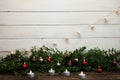New Year and Christmas background with candles. Wood texture and garland.