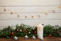 New Year and Christmas background with candles. Wood texture and garland.