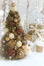 New Year, Christmas background, rustic style. Festive Christmas tree in gold on white wood background and craft boxes tied with sa