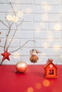 New Year, Christmas background. New Year's decor on a red table with red wooden house, toy bird and star Royalty Free Stock Photo