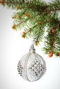 New Year. Christmas. Beautiful Round silver Christmas toy hanging on the branches of a Christmas tree, isolated on a white Royalty Free Stock Photo