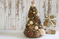 New year, Christmas card.New Year, Christmas background, rustic style. Festive Christmas tree in gold on white wood background and Royalty Free Stock Photo