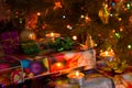 New Year and Christmas celebration composition: gift boxes and burning candles under the Christmas tree