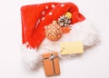 New year and christmas celebration. Santa hat with christmas gift box. Keep family traditions. Santa red hat white