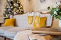 New Year and Christmas Celebration. Two Champagne Glasses over Golden Blinking christmas tree, Holiday Background Royalty Free Stock Photo