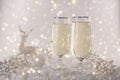 New Year and Christmas Celebration .Two Champagne Glasses and Holiday decoration. Beautiful shiny place setting for Christmas. Royalty Free Stock Photo